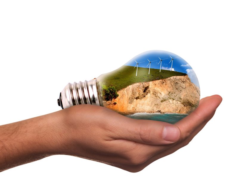 hand holding a lightbulb with the environment contained within